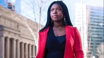 Young Black professional woman looking toward her career future, and the future is bright.